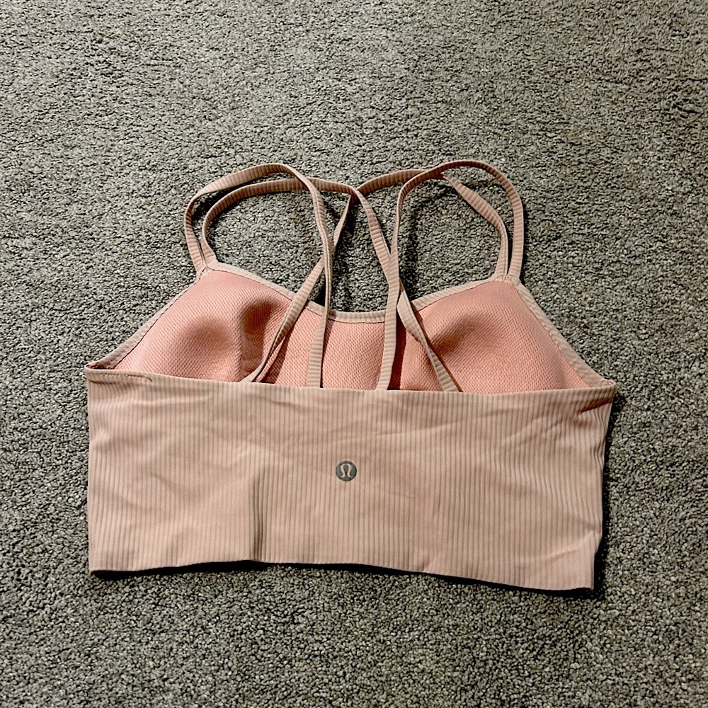 Lulu light pink cloud sports bra with a wide bottom band and medium support